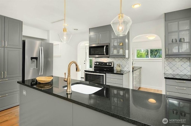 719 N 92nd St, Seattle, WA 98103 - kitchen with stainless steel appliances, gray cabinetry, a sink, decorative backsplash, and recessed lighting
