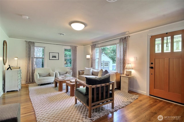 719 N 92nd St, Seattle, WA 98103 - living room with plenty of natural light, light wood finished floors, baseboards, and crown molding