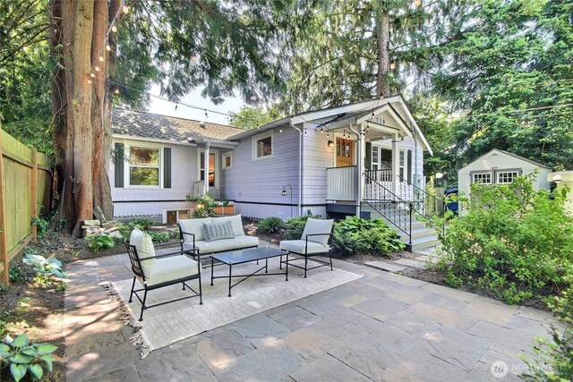 719 N 92nd St, Seattle, WA 98103 - view of patio / terrace with outdoor lounge area and an outdoor structure