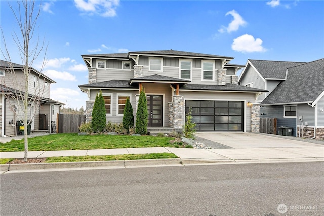 6041 Brian Ct, Ferndale, WA 98248 - prairie-style home with stone siding, concrete driveway, a garage, and board and batten siding