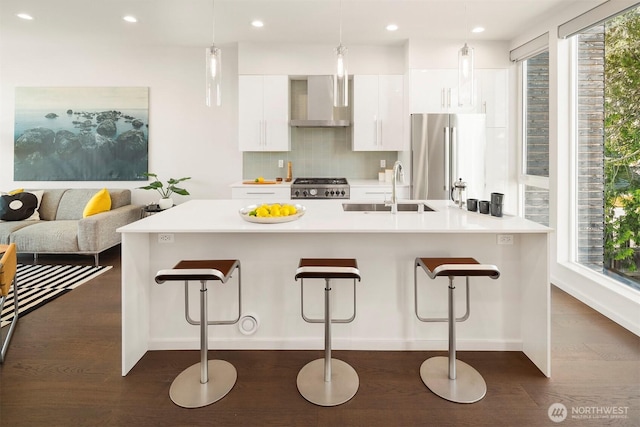922 N 36th St, Seattle, WA 98103 - kitchen with wall chimney exhaust hood, a sink, freestanding refrigerator, stove, and dark wood-style flooring