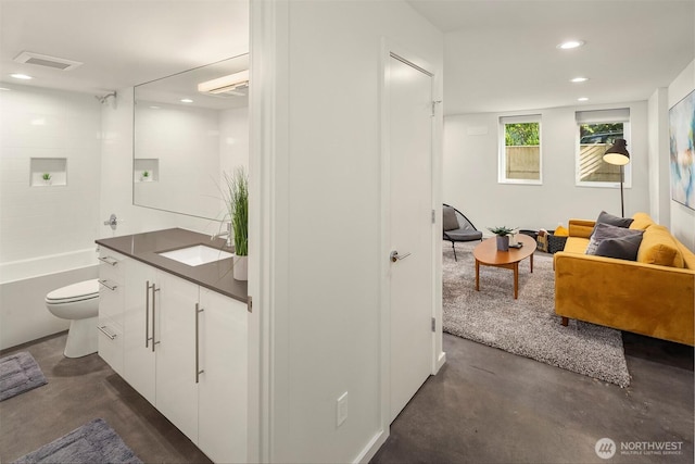 922 N 36th St, Seattle, WA 98103 - full bathroom with finished concrete floors, vanity, recessed lighting, toilet, and shower / bathtub combination