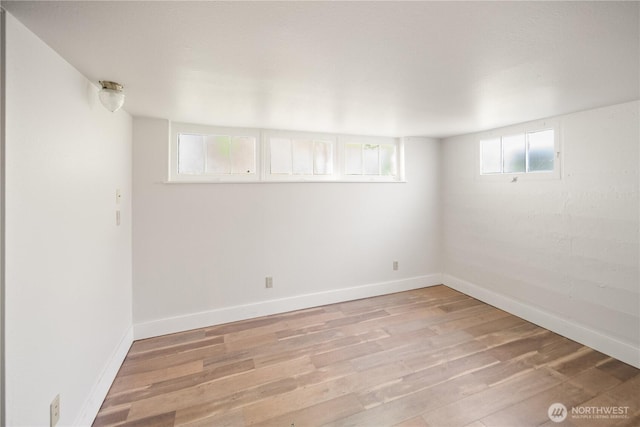 707 Ryan Ave, Sumner, WA 98390 - below grade area featuring light wood-style flooring and baseboards