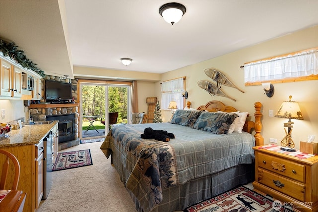 8775 Icicle Rd, Leavenworth, WA 98826 - bedroom with access to exterior, light carpet, a sink, and a stone fireplace