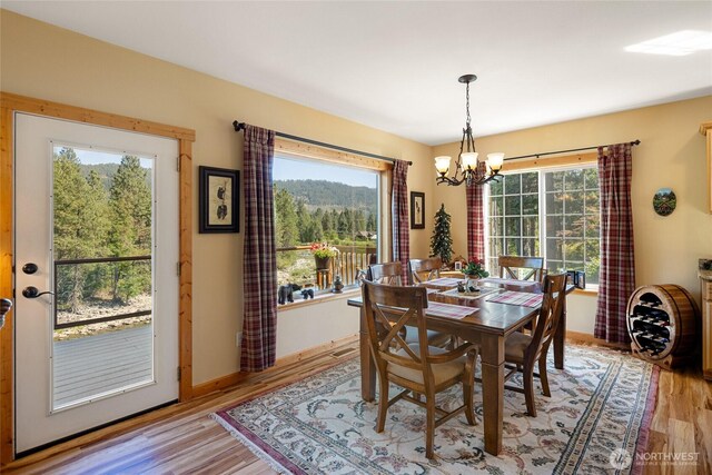 8775 Icicle Rd, Leavenworth, WA 98826 - dining room with a chandelier and light wood-style flooring