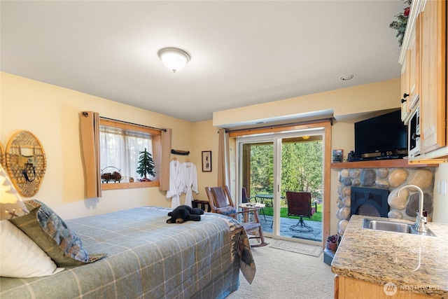8775 Icicle Rd, Leavenworth, WA 98826 - bedroom featuring a sink, light carpet, access to outside, and a stone fireplace