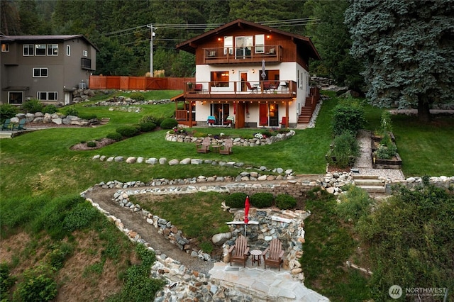 8775 Icicle Rd, Leavenworth, WA 98826 - back of house featuring stairway, a wooden deck, a forest view, a patio area, and a balcony