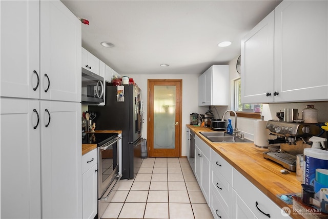 1958 12th Ave SE, Olympia, WA 98501 - kitchen with appliances with stainless steel finishes, wooden counters, a sink, white cabinets, and recessed lighting