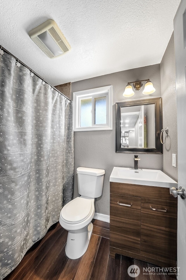 2607 S 379th Pl, Federal Way, WA 98003 - full bathroom featuring vanity, a textured ceiling, and wood finished floors
