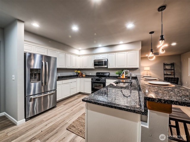 2623 189th St SE Unit A, Bothell, WA 98012 - kitchen with stainless steel appliances, a sink, a peninsula, white cabinetry, and recessed lighting