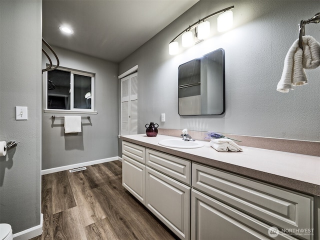 2623 189th St SE Unit A, Bothell, WA 98012 - bathroom featuring wood finished floors, vanity, toilet, and baseboards