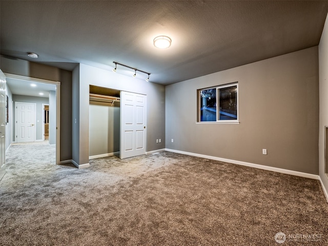2623 189th St SE Unit A, Bothell, WA 98012 - unfurnished bedroom with carpet flooring, a closet, baseboards, and track lighting