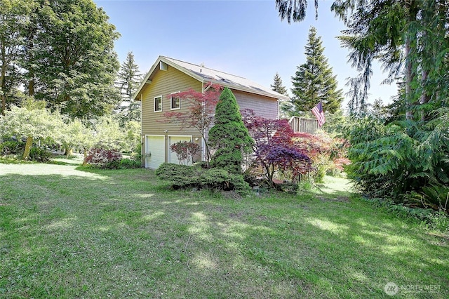 881 Lawson Rd, Camano Island, WA 98282 - view of property exterior featuring a garage and a yard