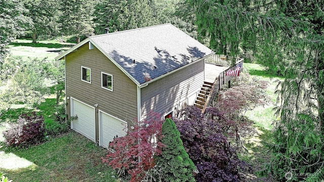 881 Lawson Rd, Camano Island, WA 98282 - view of side of property with stairway, a garage, a shingled roof, and a deck