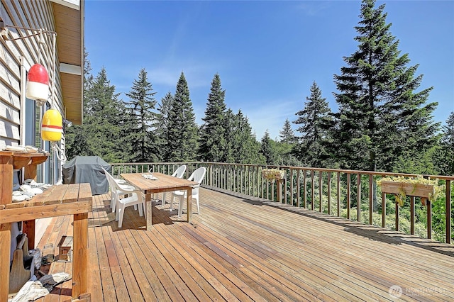 881 Lawson Rd, Camano Island, WA 98282 - wooden terrace with outdoor dining space, area for grilling, and view of wooded area