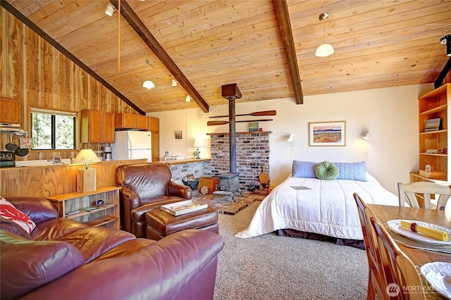 881 Lawson Rd, Camano Island, WA 98282 - carpeted bedroom featuring freestanding refrigerator, wooden ceiling, and a wood stove