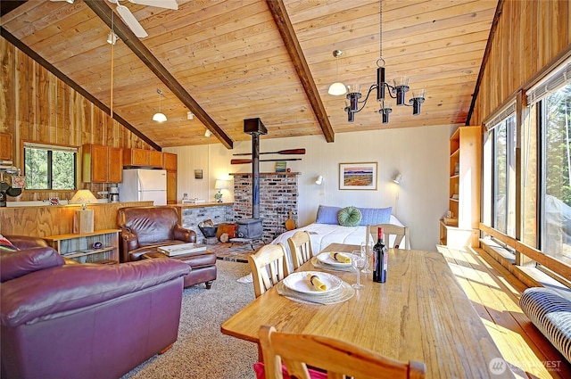 881 Lawson Rd, Camano Island, WA 98282 - living room with ceiling fan, wooden ceiling with exposed beams, a chandelier, carpet floors, and a wood stove