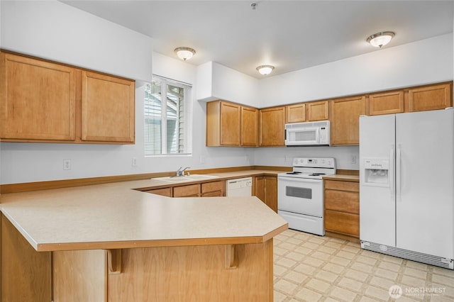 2546 Mitchell Ave Unit 2, Dupont, WA 98327 - kitchen featuring white appliances, a peninsula, light floors, light countertops, and a kitchen bar