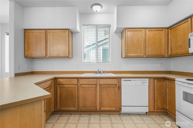 2546 Mitchell Ave Unit 2, Dupont, WA 98327 - kitchen featuring white appliances, light flooring, light countertops, and brown cabinets