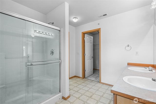 2546 Mitchell Ave Unit 2, Dupont, WA 98327 - bathroom with a shower stall, tile patterned floors, double vanity, and a spacious closet