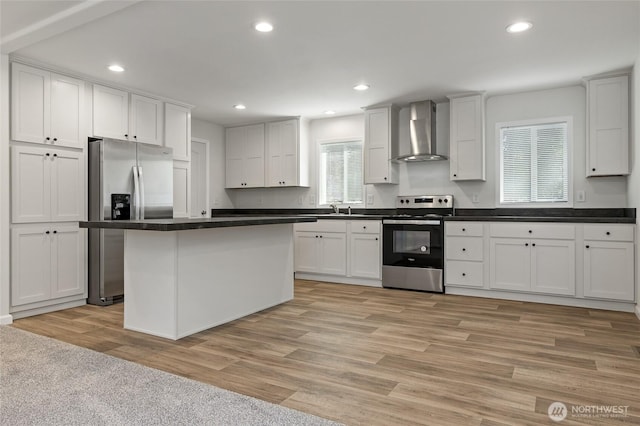 17101 Snowbell Ct SE, Yelm, WA 98597 - kitchen featuring wall chimney exhaust hood, appliances with stainless steel finishes, dark countertops, recessed lighting, and white cabinetry