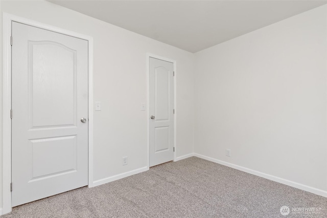 17101 Snowbell Ct SE, Yelm, WA 98597 - unfurnished bedroom featuring light carpet and baseboards