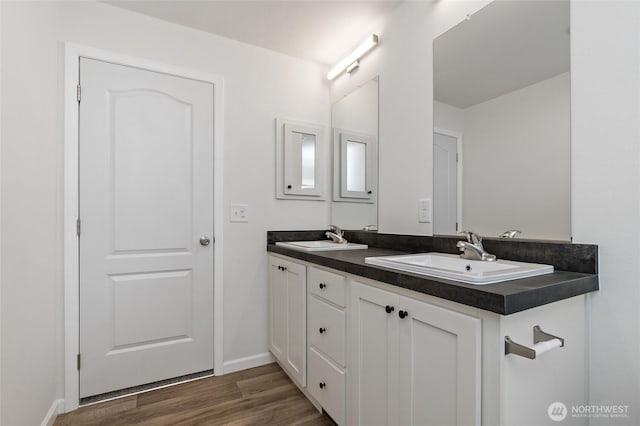 17101 Snowbell Ct SE, Yelm, WA 98597 - bathroom featuring double vanity, wood finished floors, and baseboards