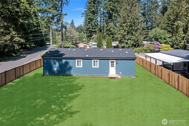 17101 Snowbell Ct SE, Yelm, WA 98597 - rear view of property with a shingled roof and view of wooded area