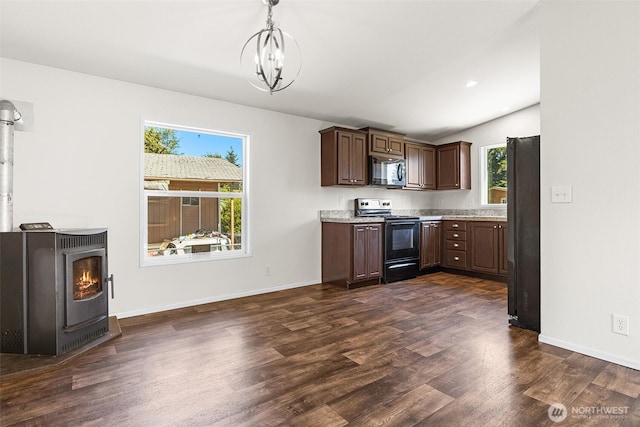22106 Cedarview Dr E, Bonney Lake, WA 98391 - kitchen with black appliances, a wood stove, dark wood-style floors, dark brown cabinetry, and baseboards