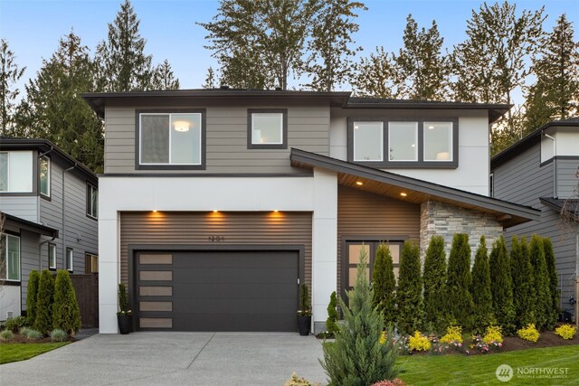 1201 222nd Ct SE, Sammamish, WA 98075 - modern home with a garage, concrete driveway, stone siding, and stucco siding