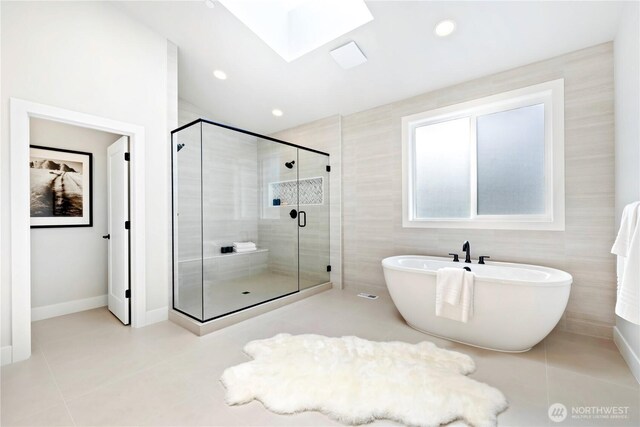 1201 222nd Ct SE, Sammamish, WA 98075 - bathroom with tile patterned floors, a skylight, a soaking tub, a stall shower, and baseboards