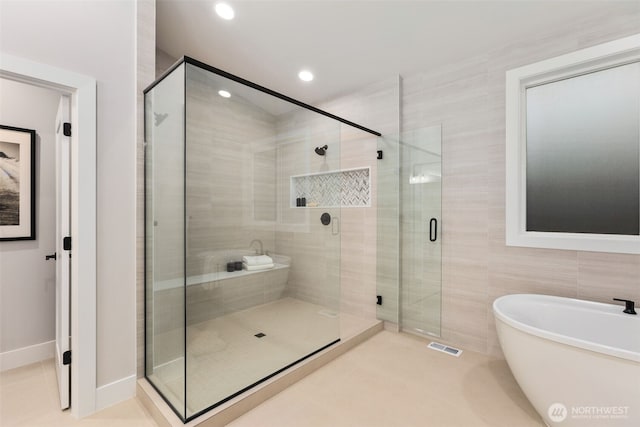 1201 222nd Ct SE, Sammamish, WA 98075 - bathroom with a freestanding tub, a shower stall, recessed lighting, tile patterned flooring, and tile walls