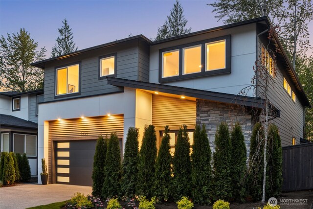 1201 222nd Ct SE, Sammamish, WA 98075 - contemporary home featuring an attached garage, driveway, stone siding, and stucco siding