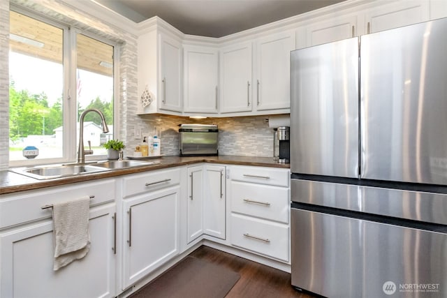 14918 Champion Estates Dr SE, Yelm, WA 98597 - kitchen with freestanding refrigerator, dark wood-type flooring, white cabinets, backsplash, and dark countertops