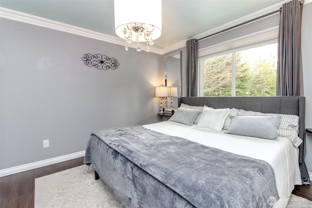 14918 Champion Estates Dr SE, Yelm, WA 98597 - bedroom with crown molding, wood finished floors, and a chandelier