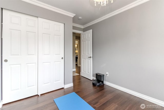 14918 Champion Estates Dr SE, Yelm, WA 98597 - exercise area featuring dark wood finished floors, a chandelier, and ornamental molding