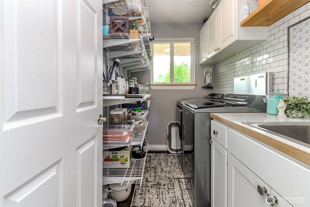 14918 Champion Estates Dr SE, Yelm, WA 98597 - washroom with washer and clothes dryer and cabinet space