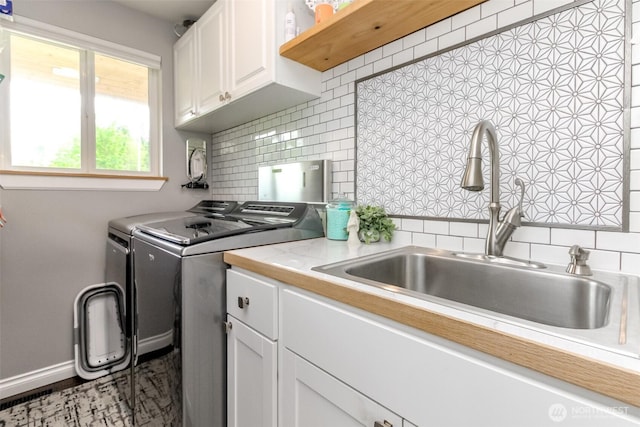 14918 Champion Estates Dr SE, Yelm, WA 98597 - kitchen featuring separate washer and dryer, light countertops, backsplash, and white cabinetry