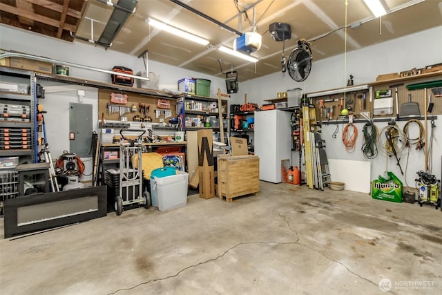14918 Champion Estates Dr SE, Yelm, WA 98597 - garage with a garage door opener, electric panel, and a workshop area