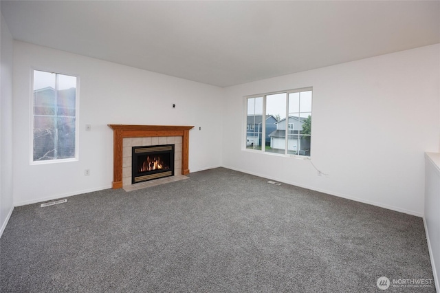 1105 200th Street Ct E, Spanaway, WA 98387 - unfurnished living room with dark carpet, a tile fireplace, and baseboards