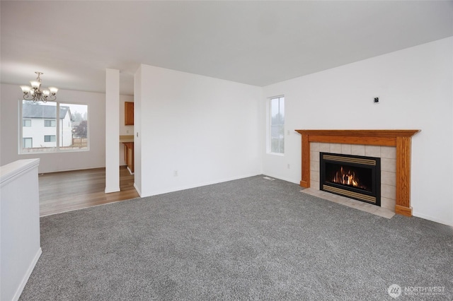 1105 200th Street Ct E, Spanaway, WA 98387 - unfurnished living room with carpet floors, a chandelier, a fireplace, and baseboards