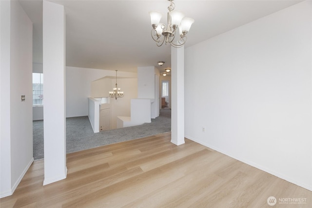 1105 200th Street Ct E, Spanaway, WA 98387 - unfurnished living room with a chandelier, wood finished floors, baseboards, and plenty of natural light