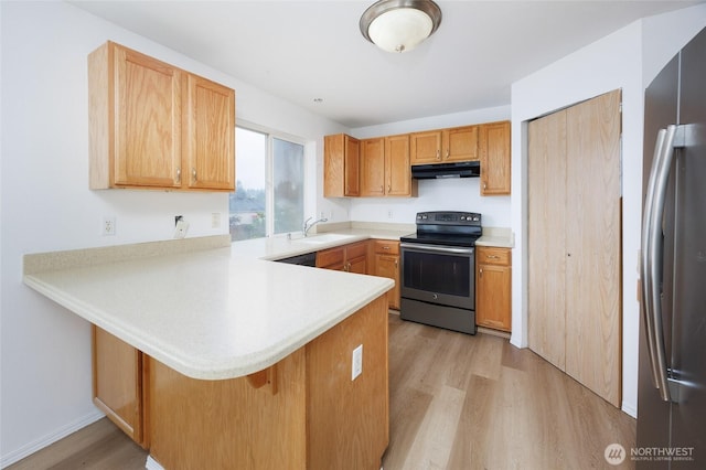 1105 200th Street Ct E, Spanaway, WA 98387 - kitchen with stainless steel appliances, light wood-style flooring, under cabinet range hood, a peninsula, and a sink