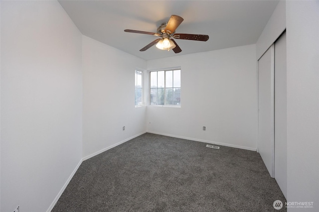 1105 200th Street Ct E, Spanaway, WA 98387 - unfurnished bedroom featuring dark colored carpet, a closet, baseboards, and ceiling fan