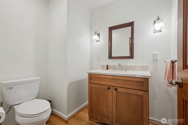 35224 28th Ave S, Federal Way, WA 98003 - bathroom with toilet, vanity, wood finished floors, and baseboards