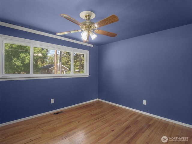 11822 10th Ave S, Seattle, WA 98168 - unfurnished room featuring plenty of natural light, a ceiling fan, and wood finished floors