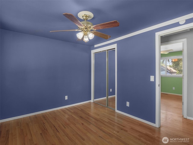 11822 10th Ave S, Seattle, WA 98168 - unfurnished bedroom featuring wood finished floors, a closet, and a ceiling fan