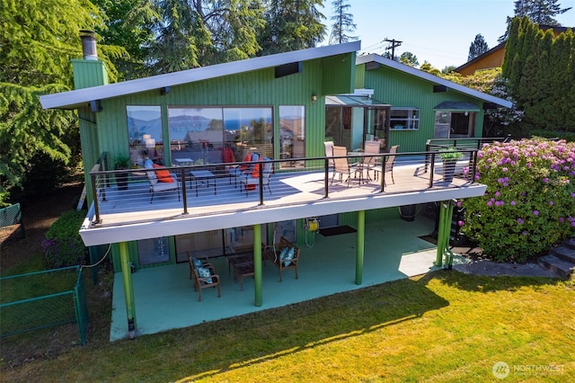 714 SW 296th St, Federal Way, WA 98023 - back of property featuring a patio area, a chimney, a lawn, and a wooden deck