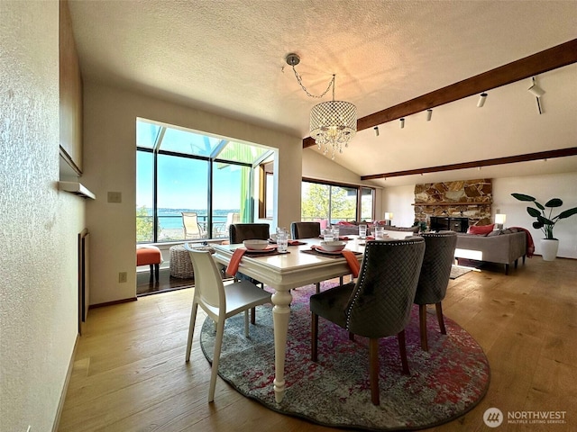 714 SW 296th St, Federal Way, WA 98023 - dining space with light wood-style floors, lofted ceiling, a textured wall, a chandelier, and a textured ceiling