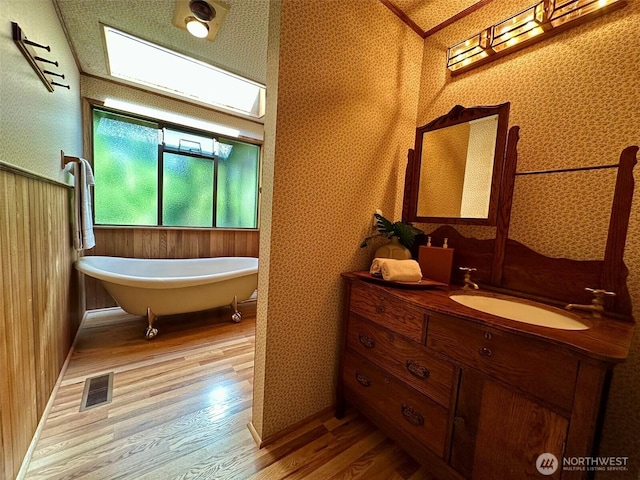 714 SW 296th St, Federal Way, WA 98023 - bathroom featuring wood finished floors, wallpapered walls, vanity, and a soaking tub